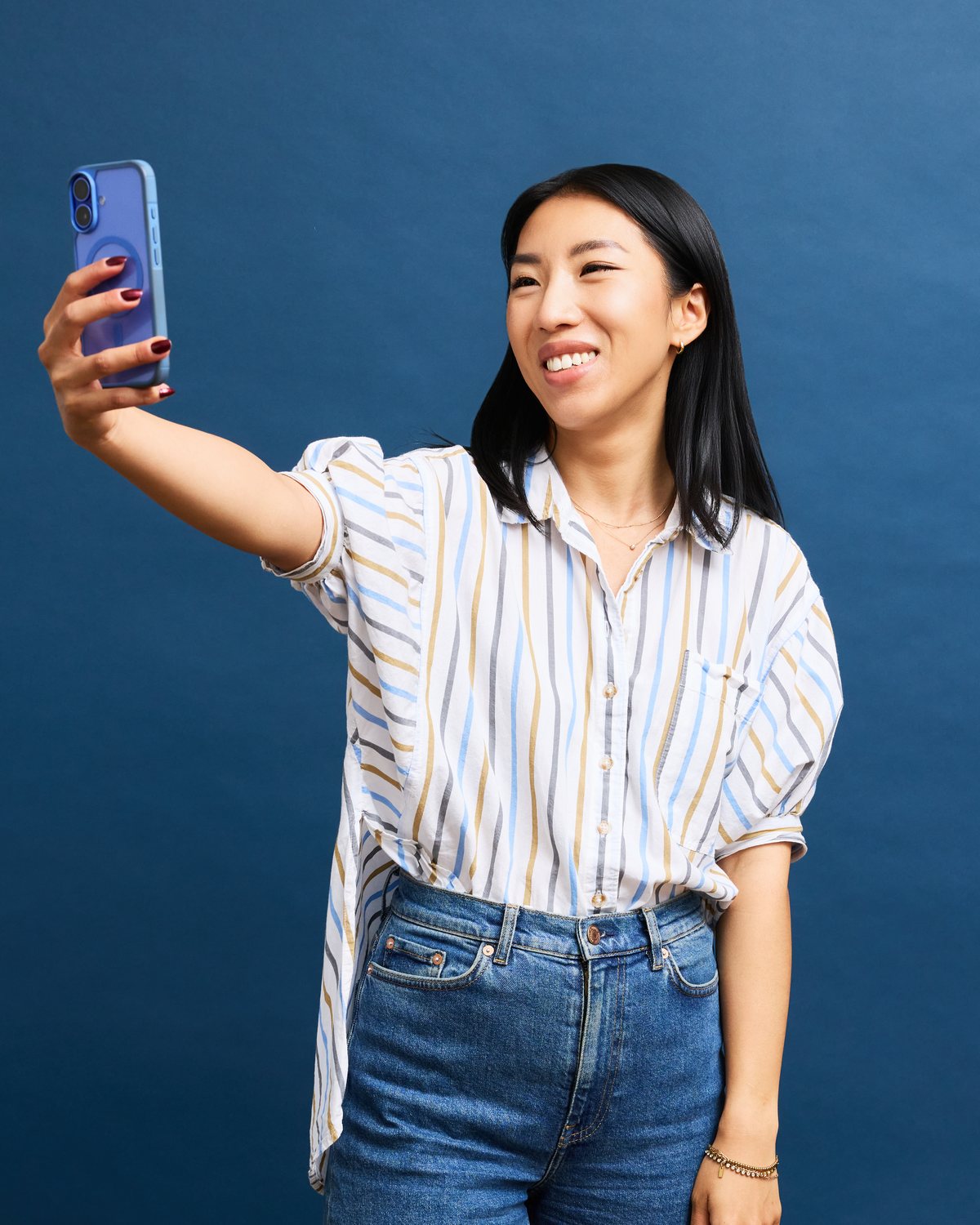 Hannah filming content on her phone