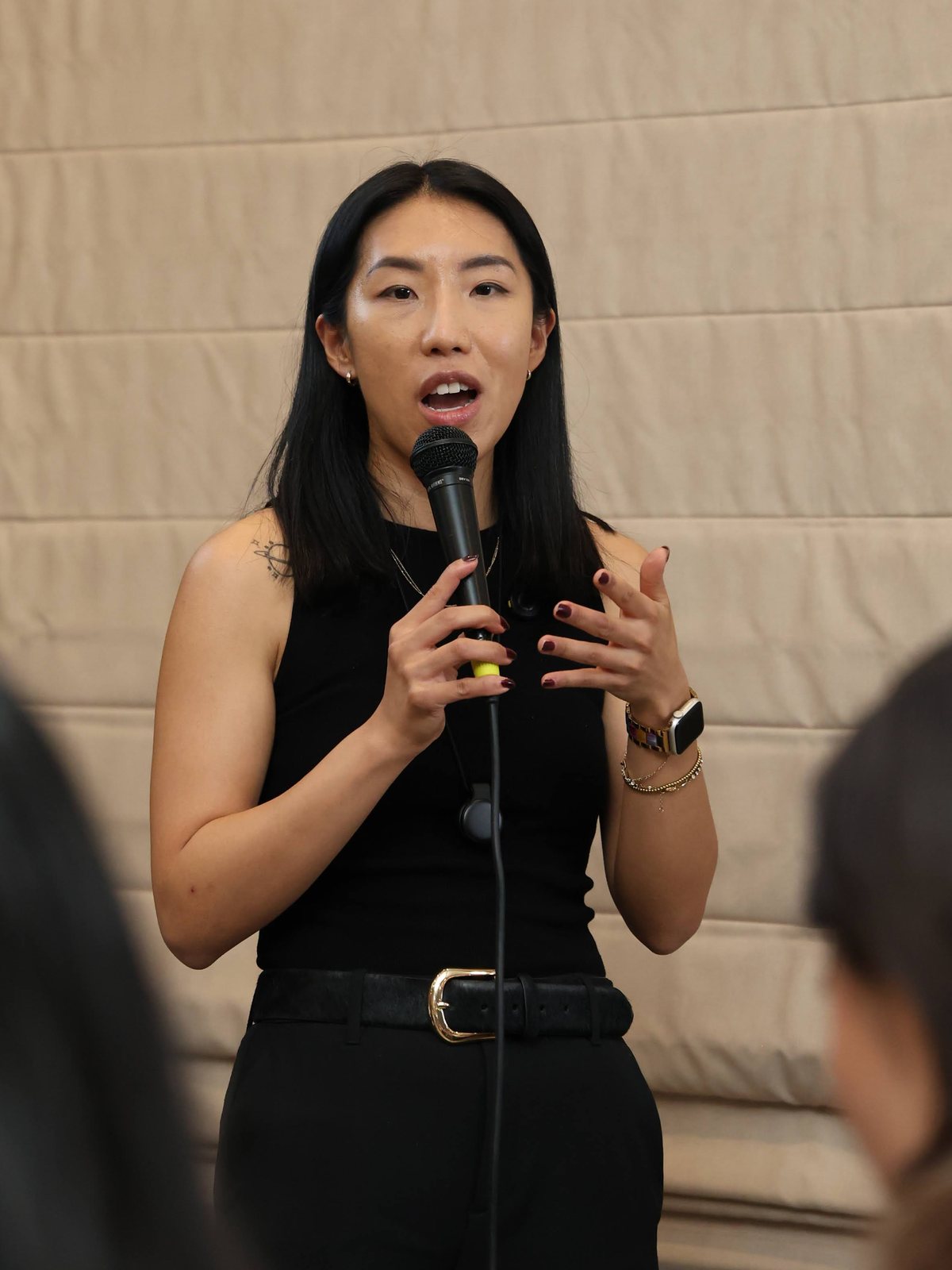 Hannah speaking at an event in NYC